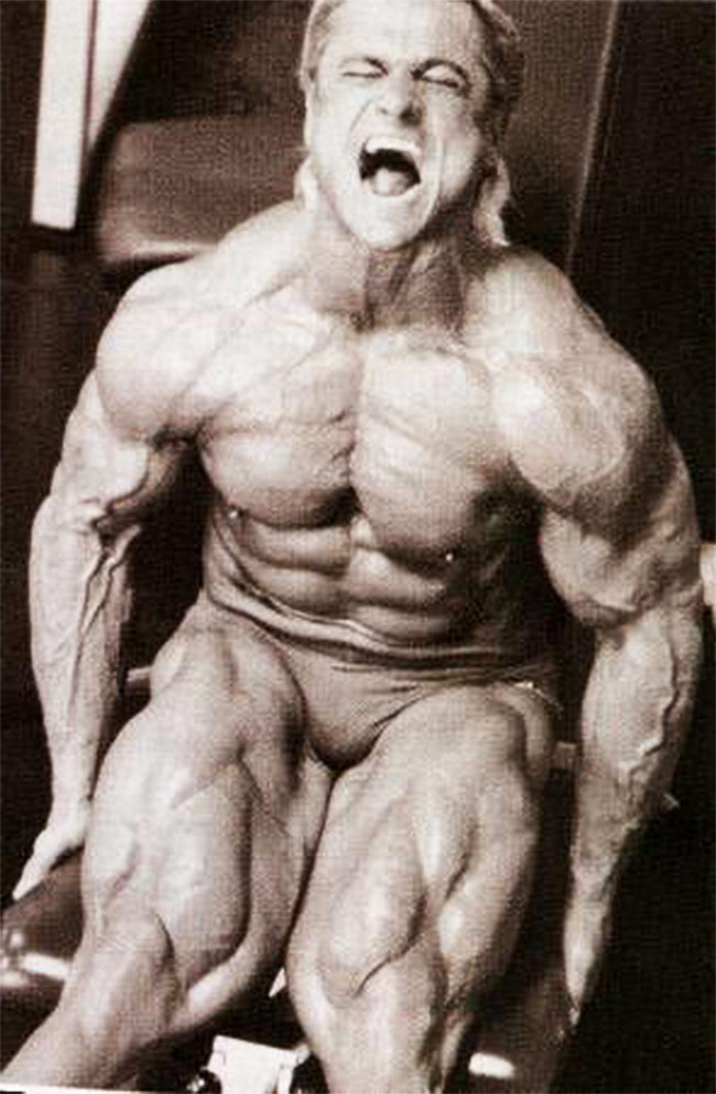 Tom Platz training his legs showing his muscular size and definition on his trademark legs for all to see.