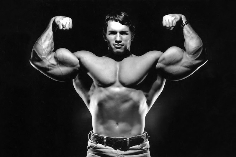 Arnold Schwarzenegger flexing biceps