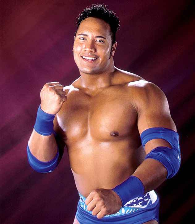 Dwayne Johnson The Rock in his younger wrestling days looking at the camera and smiling