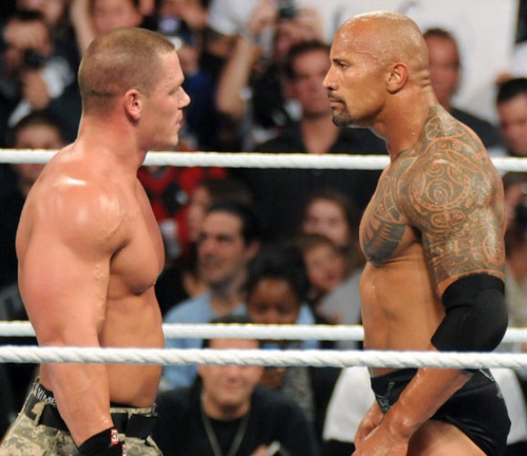 Dwayne Johnson The Rock facing John Cena in a ring