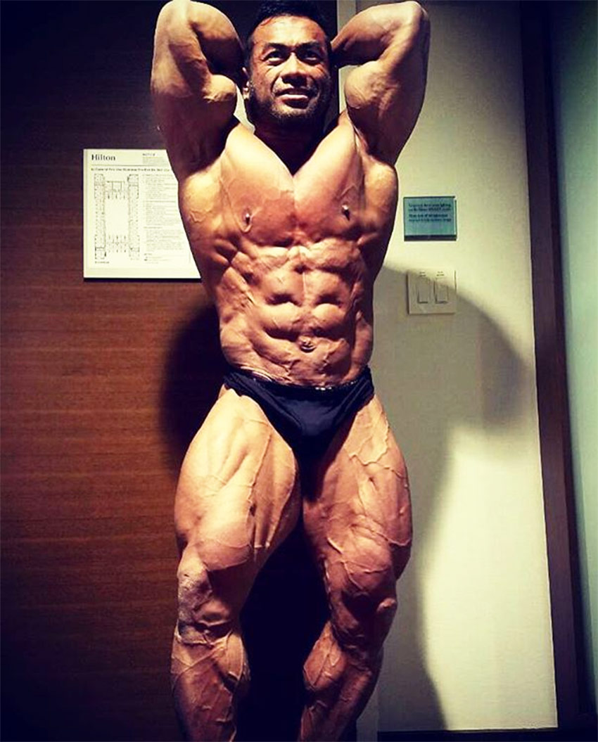 Hidetada Yamagishi on stage flexing abs