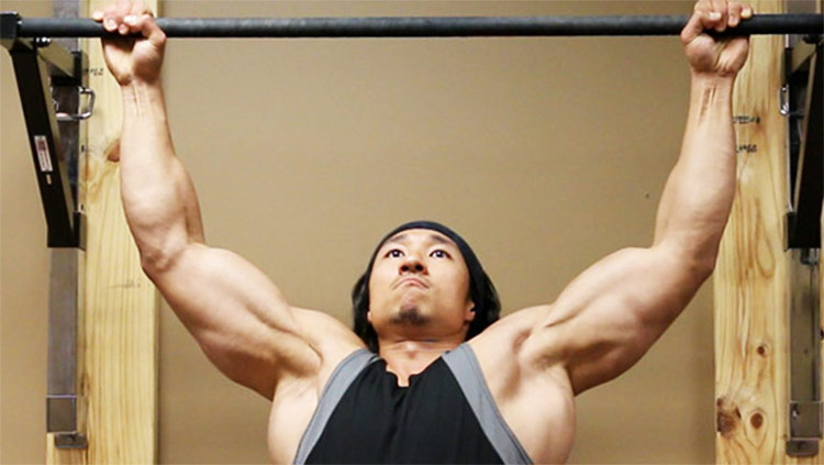 Mike Chang performing pull ups.