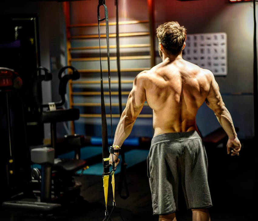 halim baydur stands in the gym showing his back to the camera