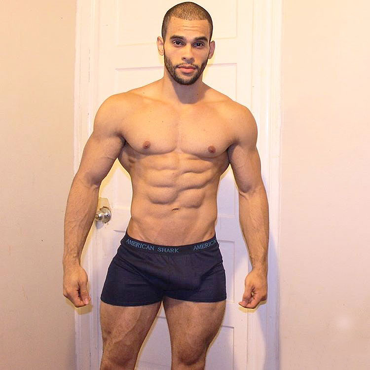 Alex Los Angeles standing in his underwear at home looking muscular and ripped with large quads, chest, and arms