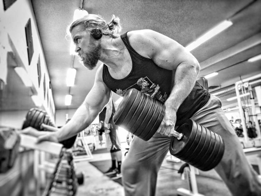 One of the Buff Dudes doing heavy dumbbell rows in the gym