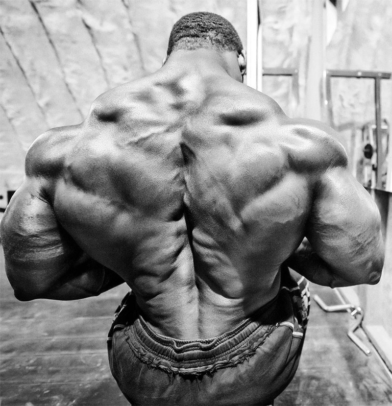 Cedric-McMillan-showing-his-huge-back while pulling weights.