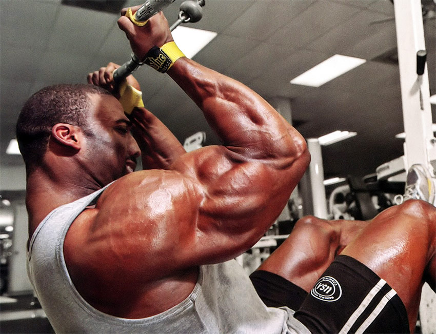 Cedric McMillan training his back and arms in the gym.