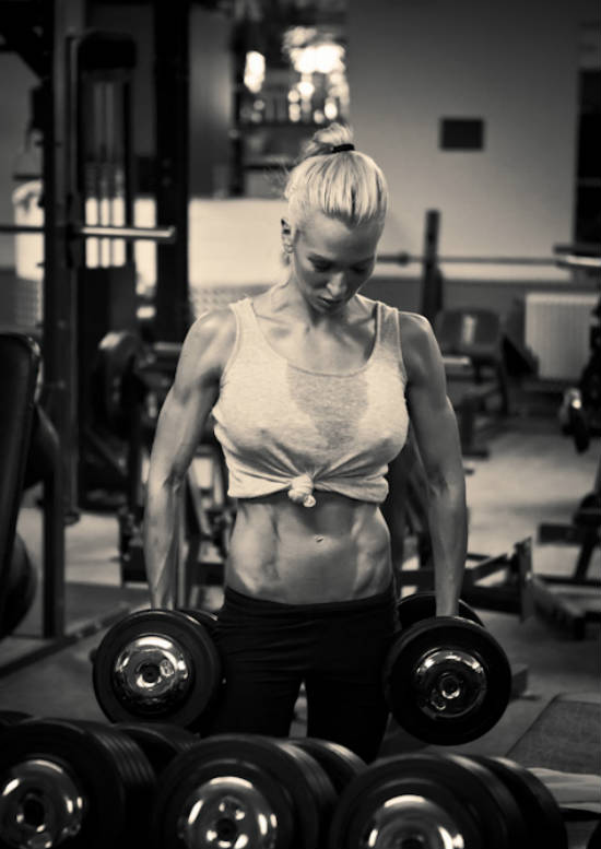 Cornelia Ritzke standing in the gym with dumbbells