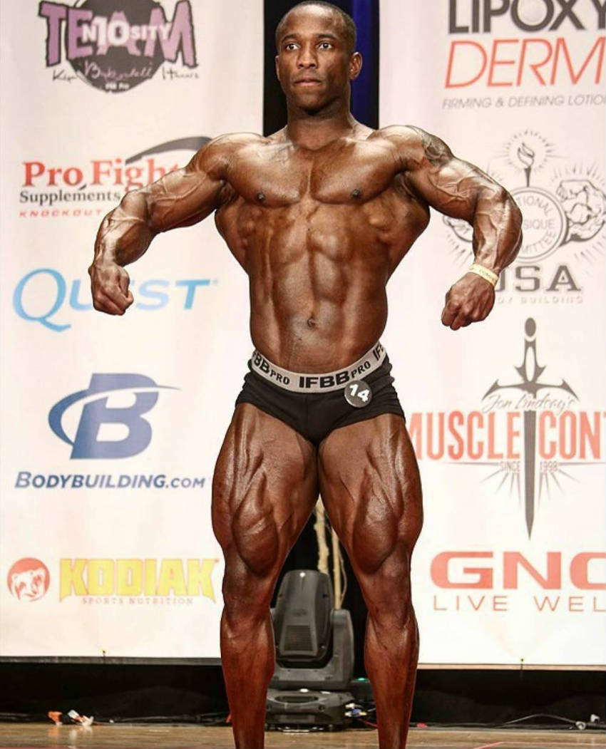 Damion Rickett posing at a competition and showing his full body after a long preparation season
