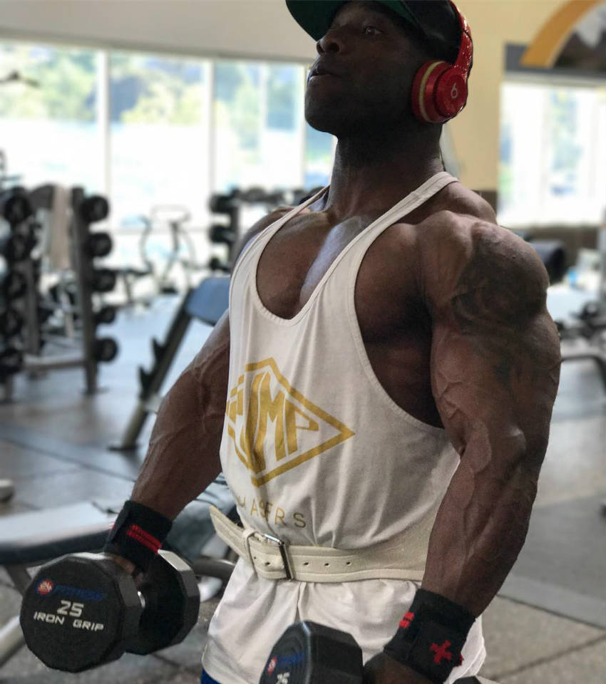 Damion Ricketts getting ready to complete an exercise with two dumbbells 