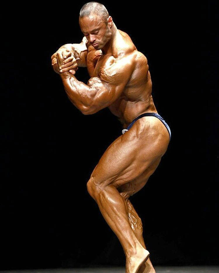 Frank Mcgrath posing and flexing his bicep at a competition