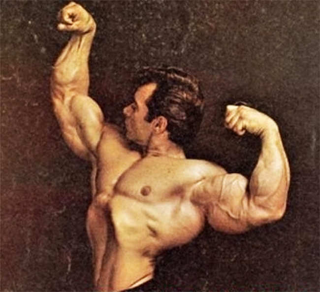 Freddy Ortiz flexing his arms for a professional photoshoot.