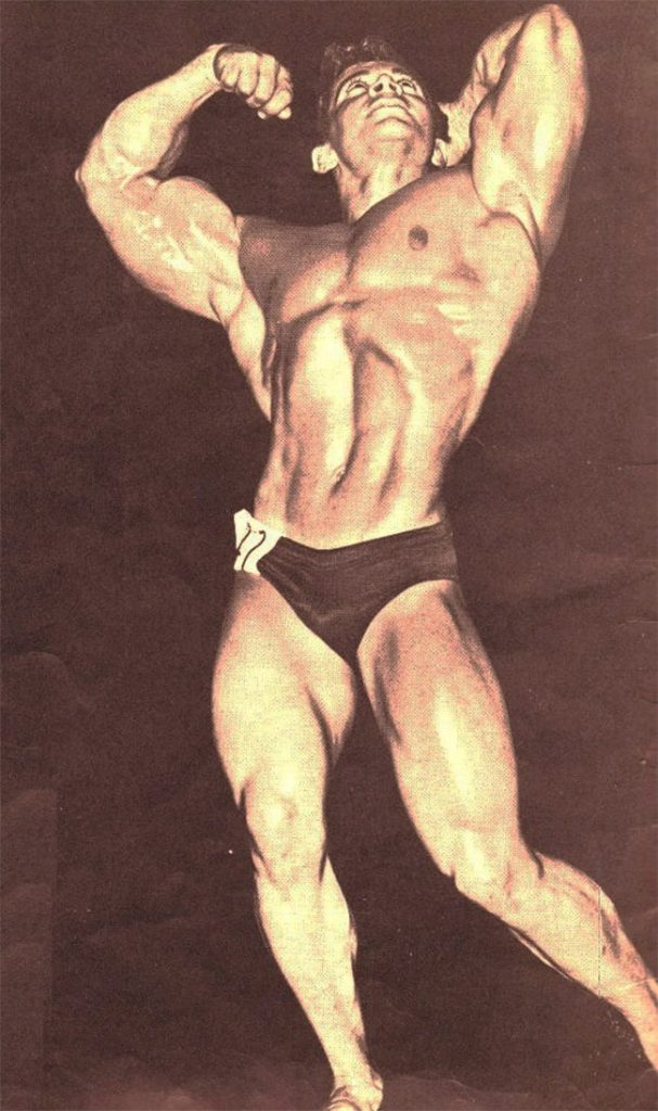 Freddy-Ortiz-posing-on-stage-showing-his-muscularity-as-a-bodybuilder