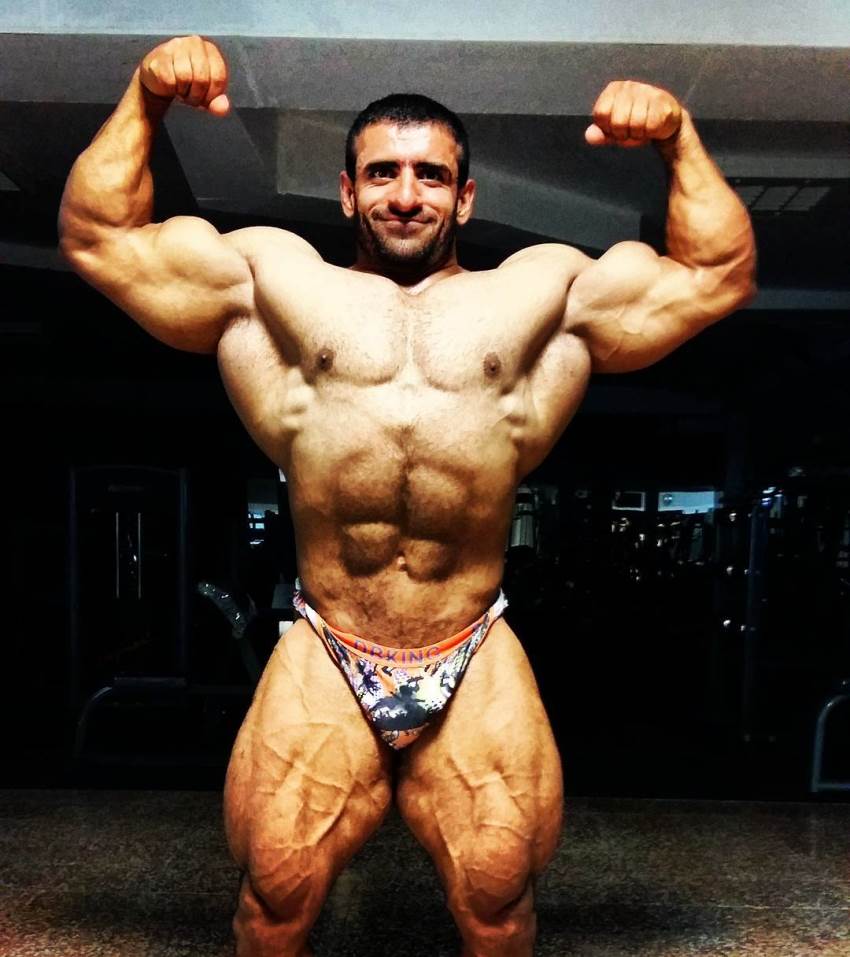 Hadi Choopan Front Double biceps pose, showing his big and lean physique