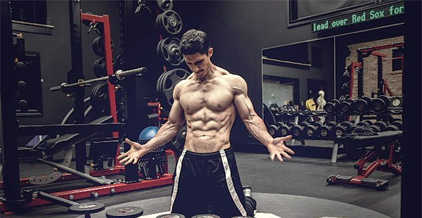 Jeff Cavaliere posing in his private gym, while displaying his muscular definition.