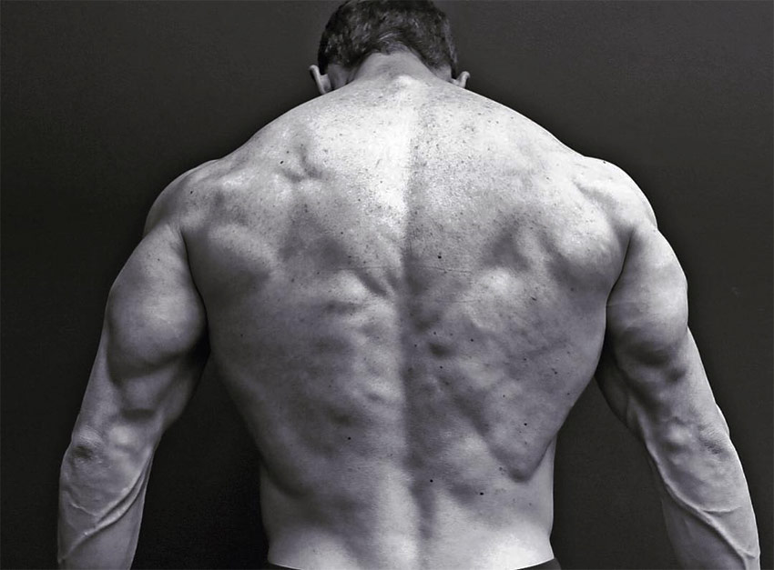 Jeff Cavaliere displaying his back definition and size for a photo on his Instagram.