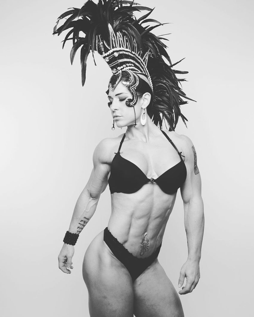 Kortney Olson wearing a party carnaval outfit looking lean and muscular