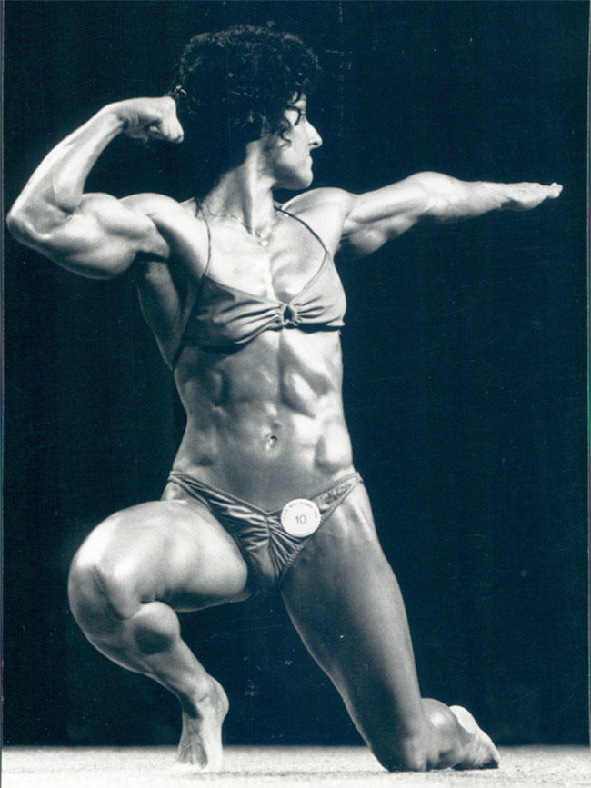 Laura Combes showing her figure in her competition, making bodybuilding history.