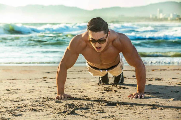 Long Wu completing a press-up on the beach