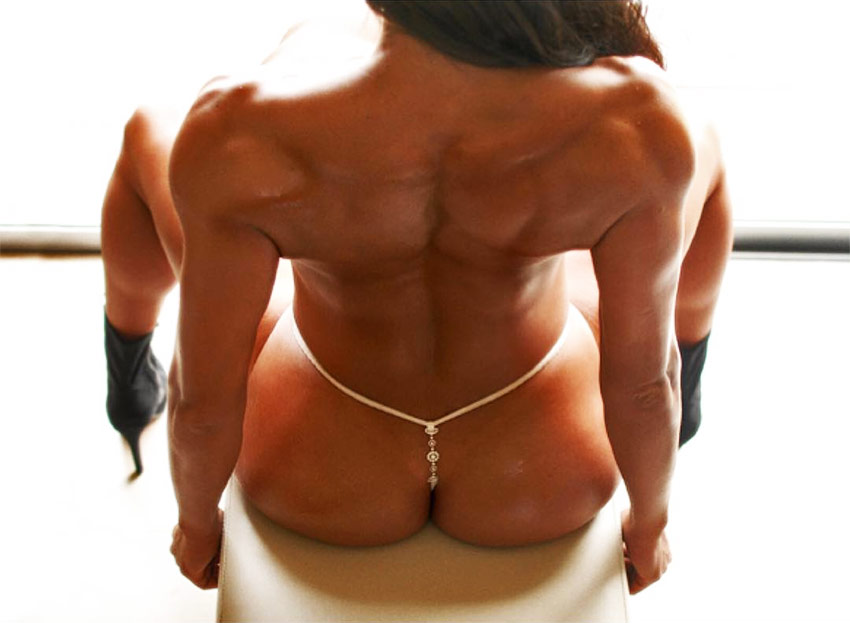 Maria Villalba showing her muscular definition on her back and glutes.