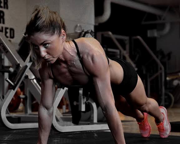 Michaela Augustsson doing pushups in the gym, working on her ripped upper body