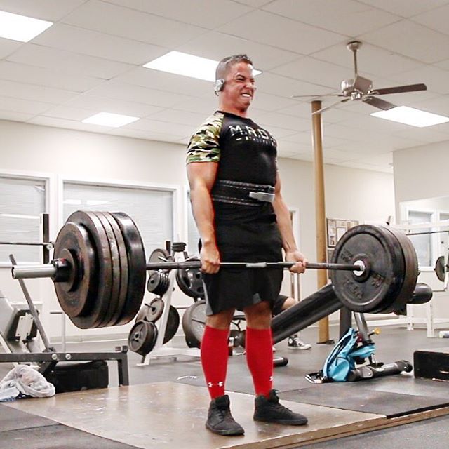 Nick Wright with a pained grimace, doing heavy deadlifts