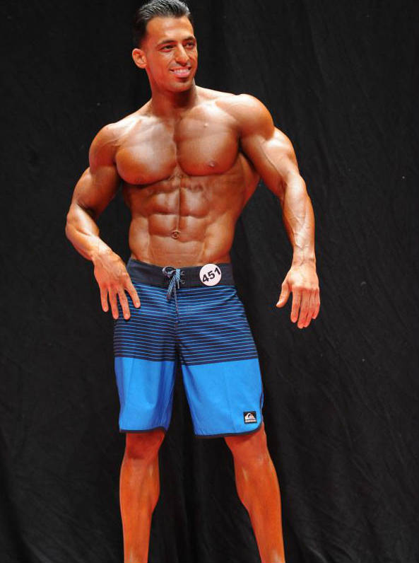 arya saffaie in blue shorts competing