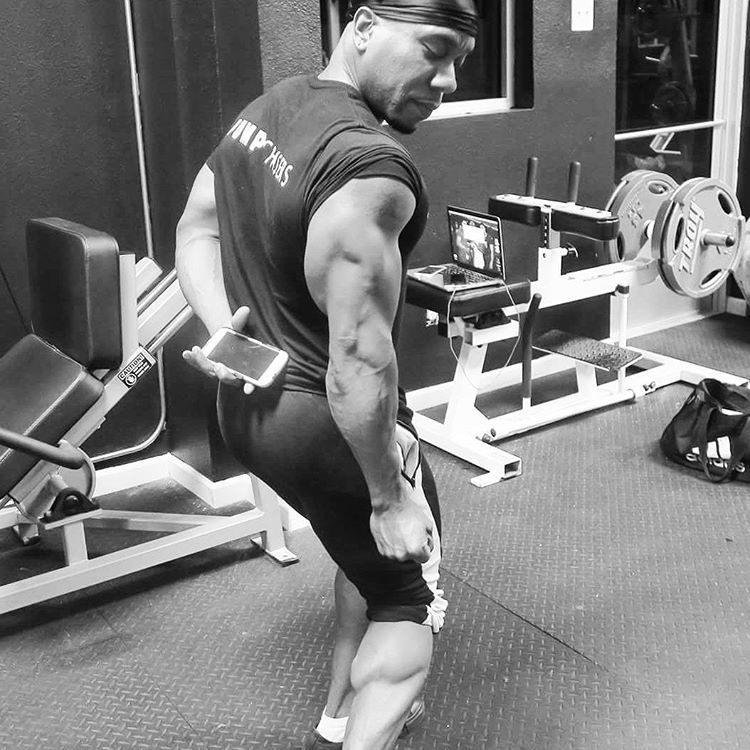 Chris Jones showing his triceps development in a gym