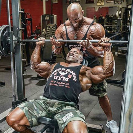 juan morel lifting a barbell with a spotter