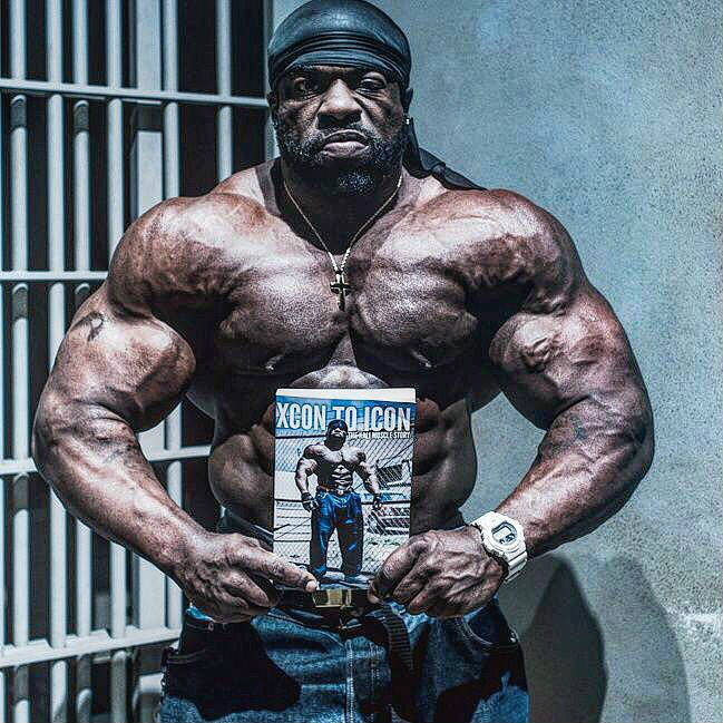 kali muscle posing with his book