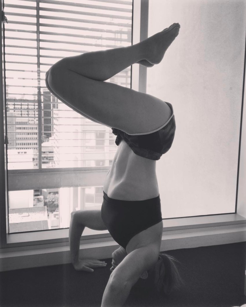 Michelle Bridges showing off her handstand skills, and also showing her toned body