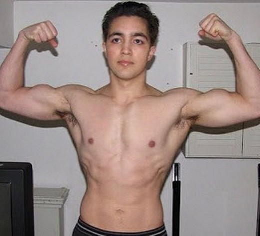 Young Omar Isuf in a front double biceps pose