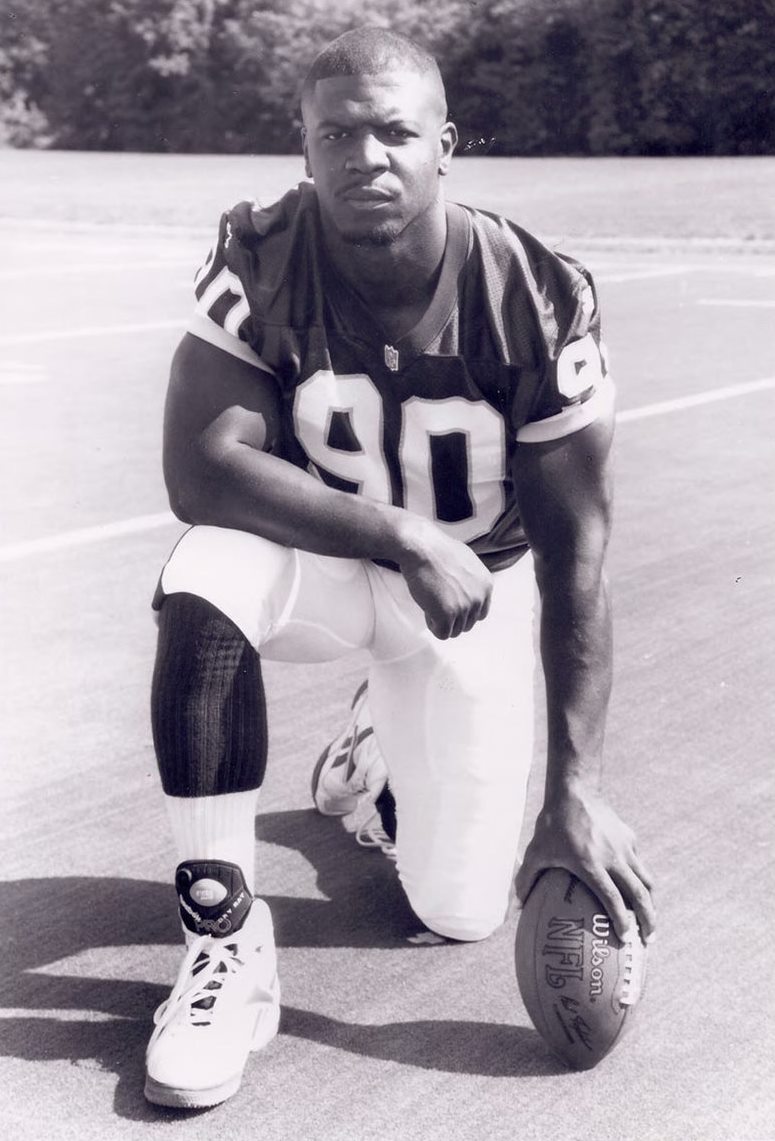 Picture of Terry Crews during his NFL days, wearing a football-team jersey with a ball in his hand