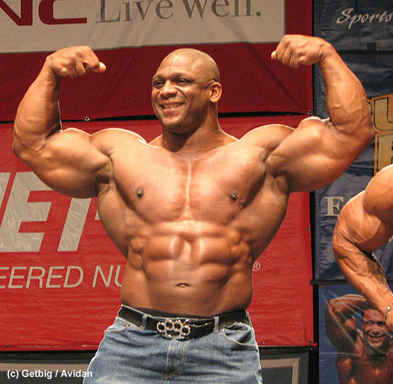 quincy taylor flexing his arms with knuckleduster belt buckle