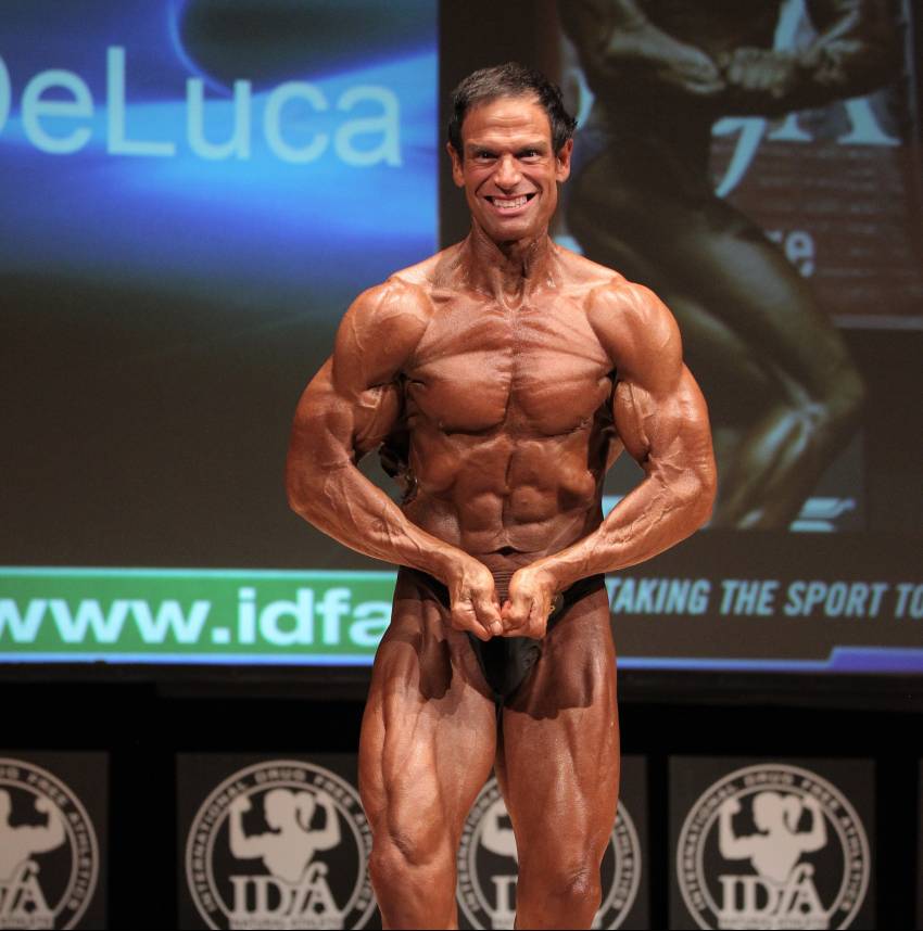 rob deluca flexing most muscular on the bodybuilding stage, looking ripped and muscular