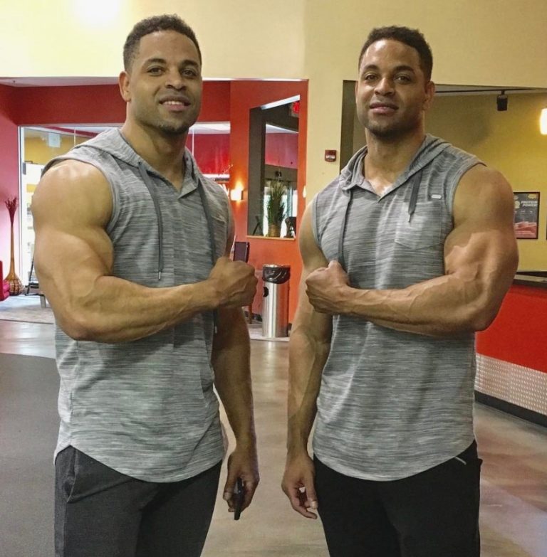 The Hodgetwins flexing their arms at the camera.