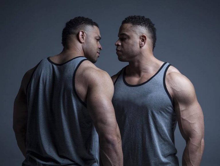 The Hodgetwins looking extremely seriously each other directly in the eyes.