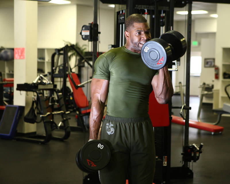 xavisus gayden completing a bicep curl in his marine training clothes