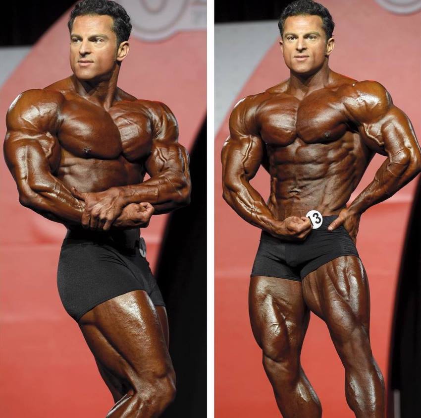 Arash Rahbar in two pictures, standing on the Olympia stage, tanned up, displaying his awesome classic physique to the audience