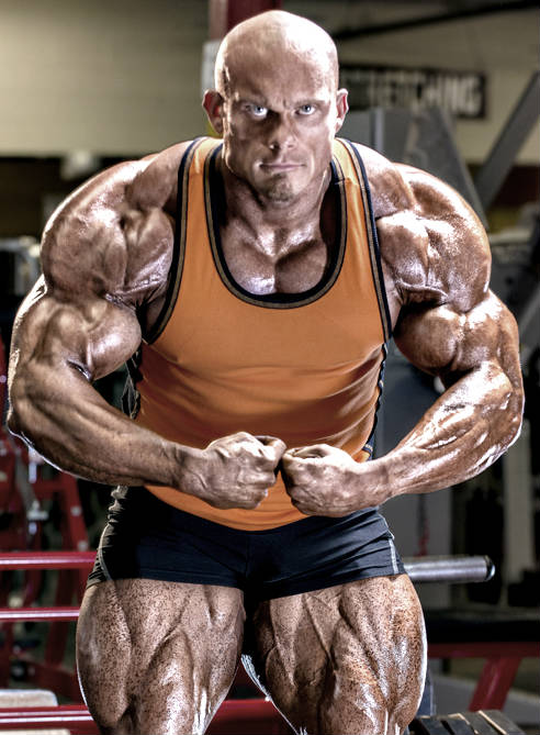 Ben Pakulski showing off his large and toned quads, well-built arms and large chest