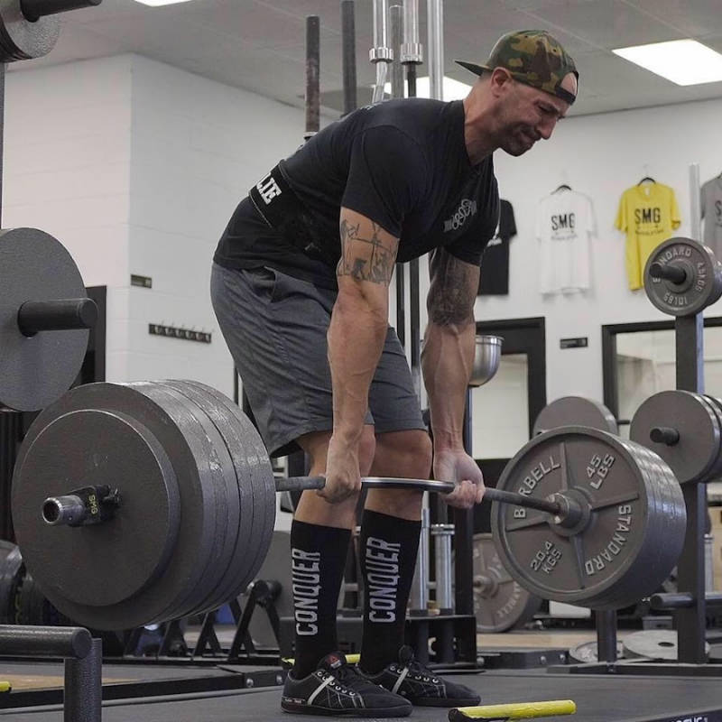 Brandon Campbell completing a deadlift and showing his large arms 