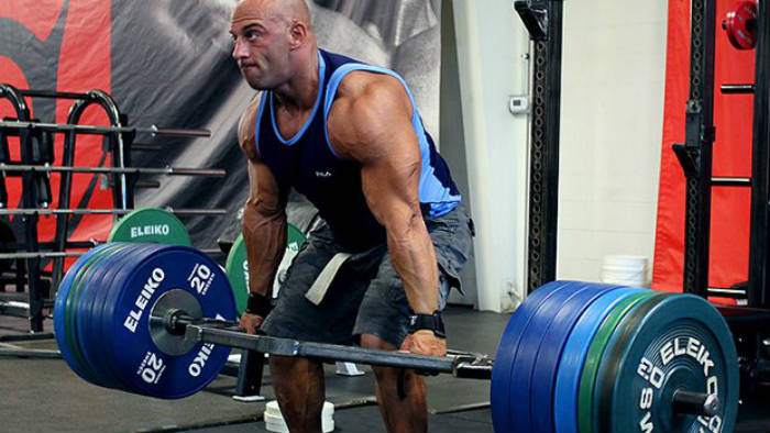 Christian Thibaudeau completing a deadlift, showing his large arms and legs 
