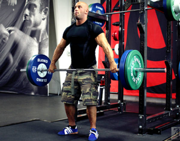 Christian Thibaudeau completing a deadlift, showing his large arms and legs 