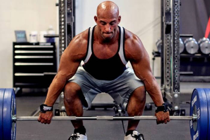 Christian Thibaudeau completing a deadlift, showing his large arms and legs