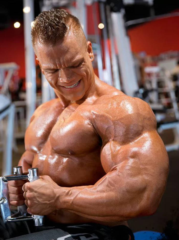 Dallas Mccarver completed a lateral row, showing his large arms, pumped chest and large abs