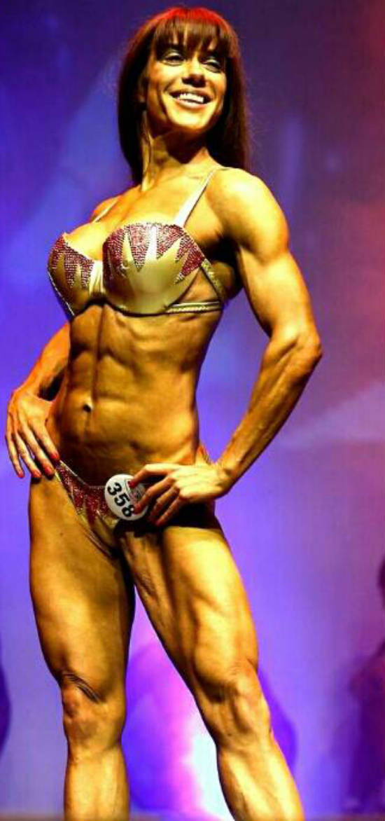 Donna De Lisser posing at the Miami Pro Competition, showing her toned abs and delts