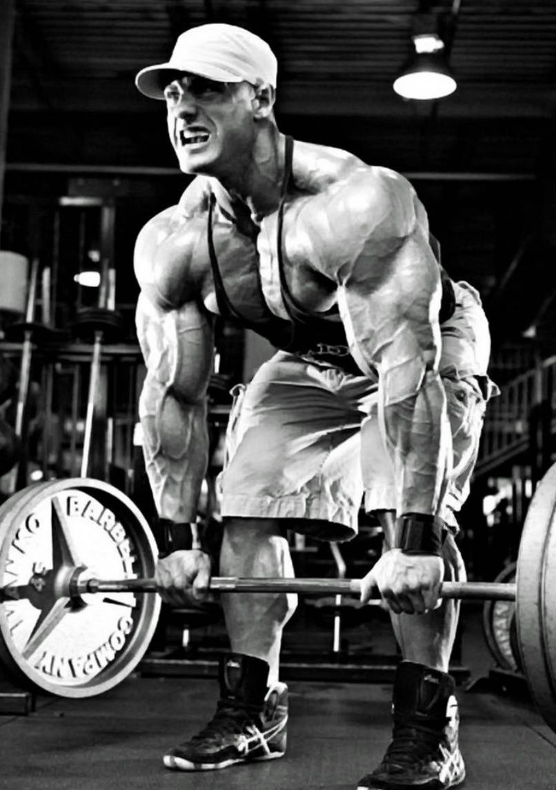 Evan Centopani completing a deadlift, showing his large arms, chest and legs