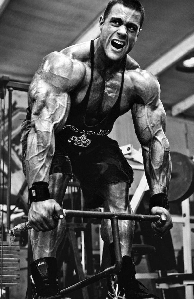 Evan Centopani completing a deadlift, showing his large arms, legs and chest