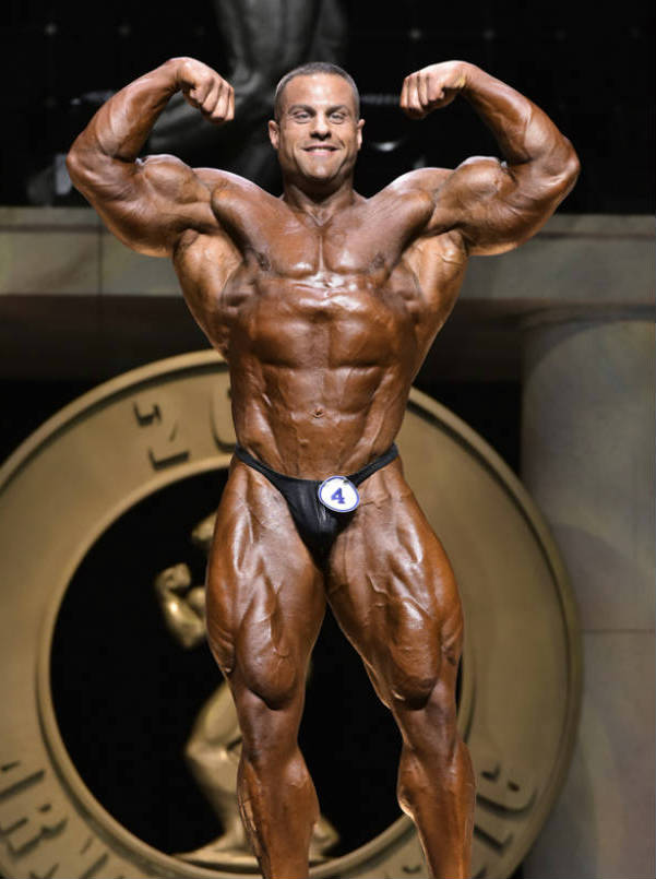 Evan Centopani showing his ripped abs, large legs and arms
