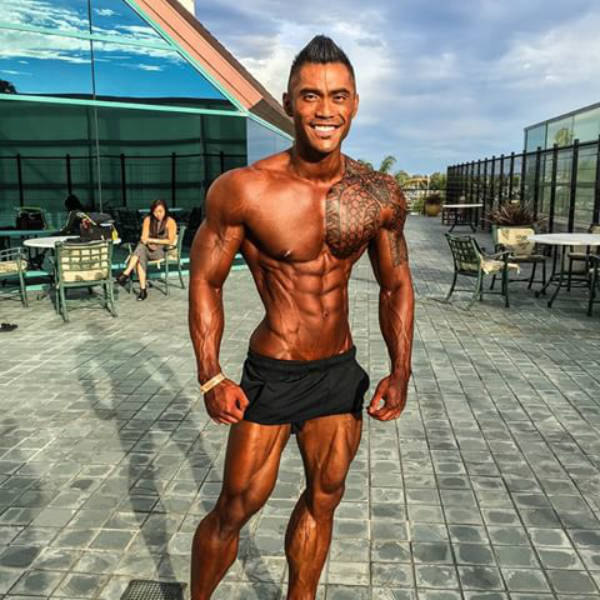 Jake Alvarez showing his full bronzed body before he poses at a competition